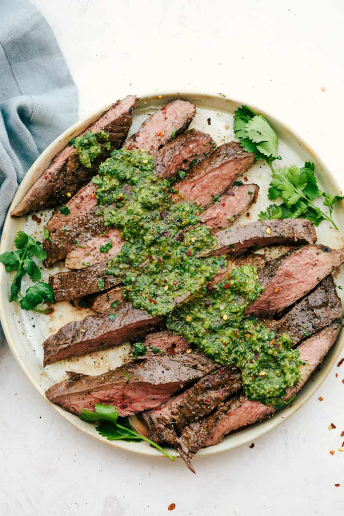 This perfectly grilled flank steak is tender and juicy and topped with the most delicious chimichurri sauce